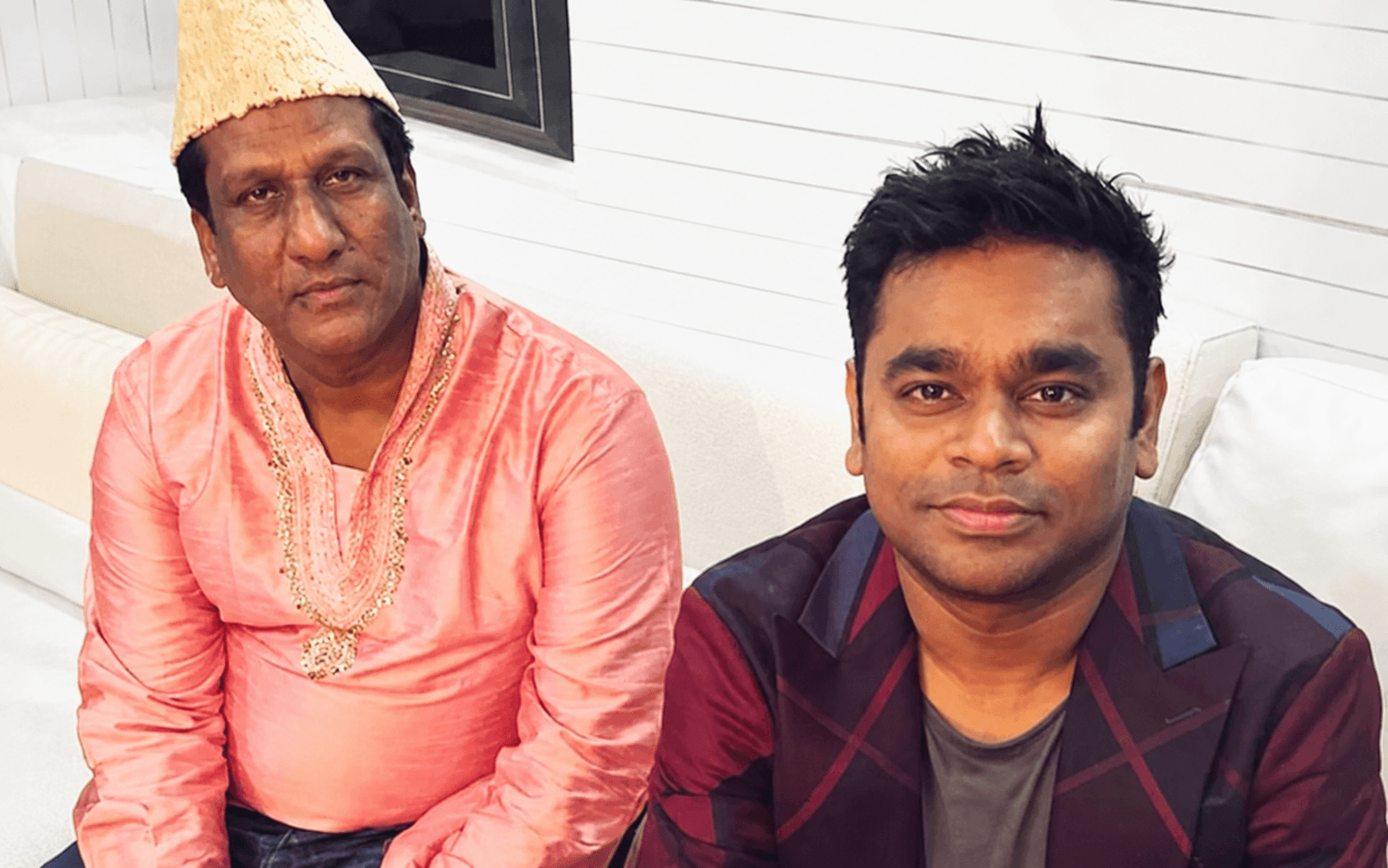 Ustad Chand Nizami with A. R. Rahman seated on a white sofa